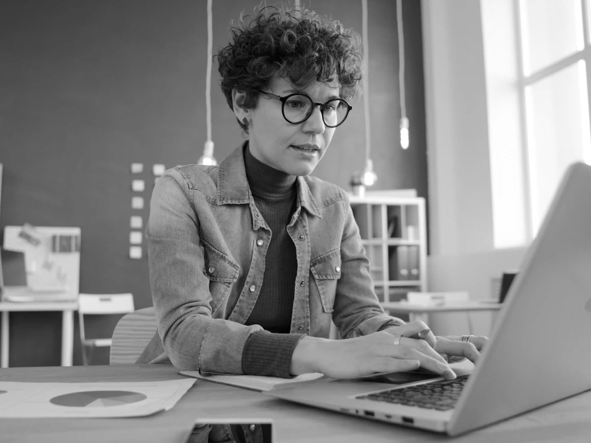 A freelancer working on her laptop at a desk
